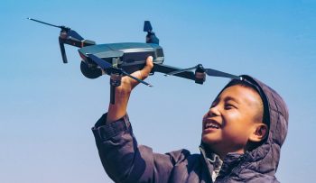 kid-holding-up-drone